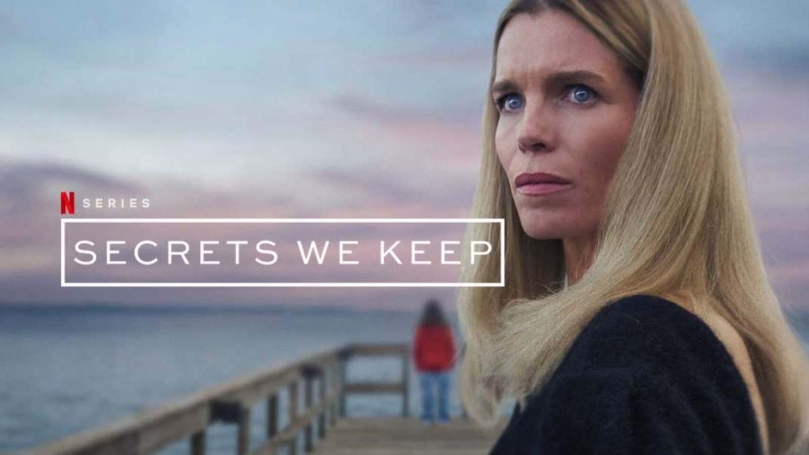 Cecilie stares intensely at the camera on a dock at sunset in Netflix’s 2025 thriller Secrets We Keep